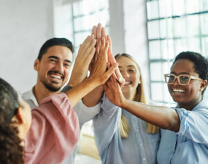 a group of people all high fiving their hands together.